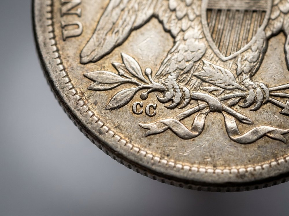 Close-up of the CC mint mark on the reverse of a Carson City Seated Liberty quarter